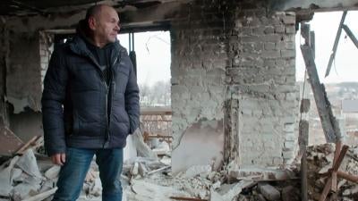 Mykhailo Yatsentiuk in the ruins of the building at 2 Pershotravneva Street in Izium, his former home, in December 2022