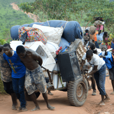 Congolese migrants who were living in Angola carry belongings near the Congolese border town of Kamako, on October 12, 2018, after returning to their country following a security crackdown by Angolan authorities. © 2018 SOSTHENE KAMBIDI/AFP/Getty Images