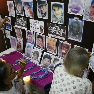 Families of victims of the "war on drugs" in the Philippines remove portraits of their slain relatives after the UN Human Rights Council passed a resolution to investigate the killings. 