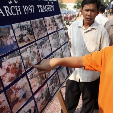 A survivor points to a picture of herself on the 11th anniversary of the March 30, 1997 grenade attack in Phnom Penh, Cambodia, March 30, 2008.