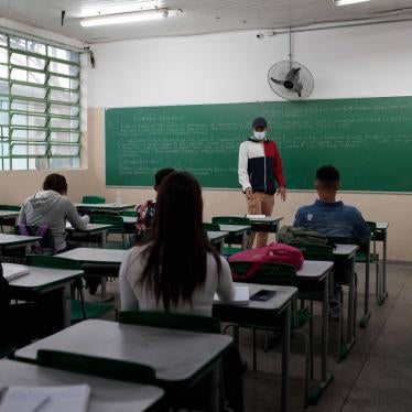 A teacher stands in front of a classroom of students