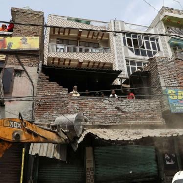 A bulldozer demolishes a shop entrance in Jahangirpuri, in New Delhi, India, April 20, 2022.