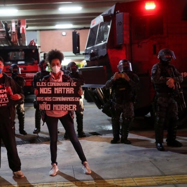 Activists protest in Sao Paulo against racism, police violence, and against a police operation that took place in Jacarezinho in Rio de Janeiro, Brazil, May 13, 2021. The placards read "Stop killing us" and "They agreed to kill us, and we agreed not to die".