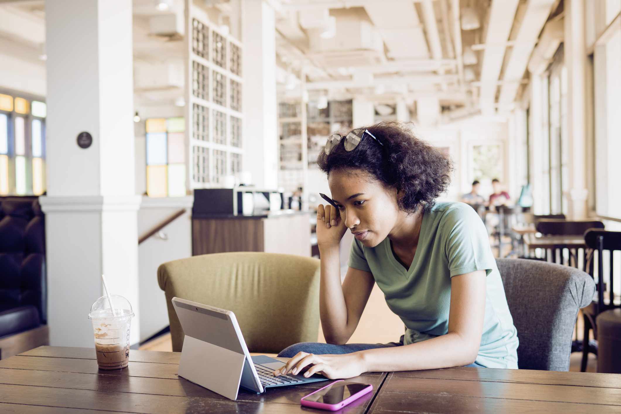 A young credit card customer checks her credit scores.