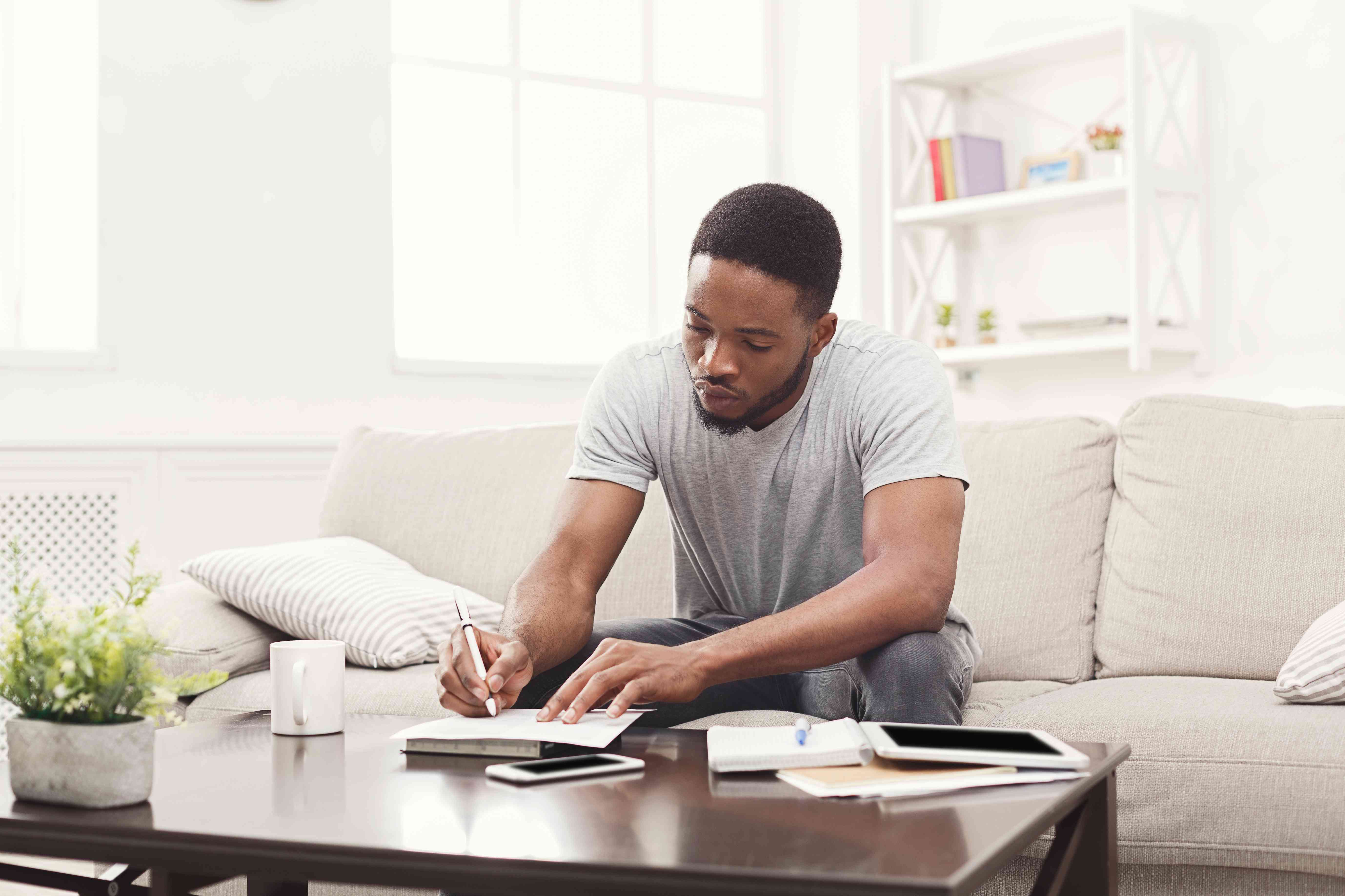 Man calculating how much student loan debt is too much