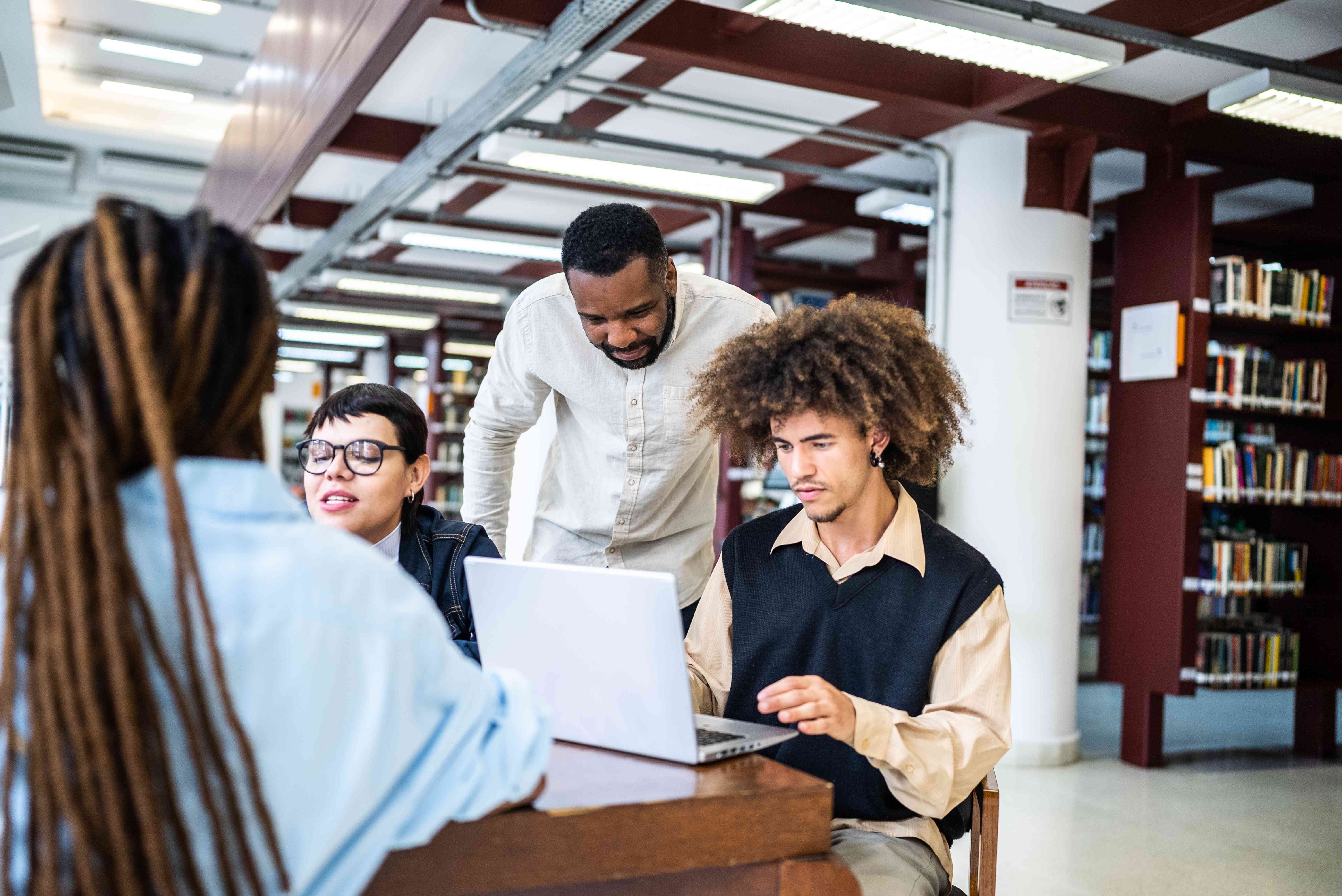 Students looking at 529 Plan at a library