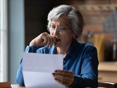 Woman reading a document at home