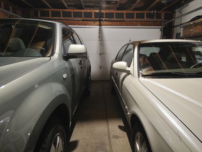 Two cars tightly parked in a two car garage