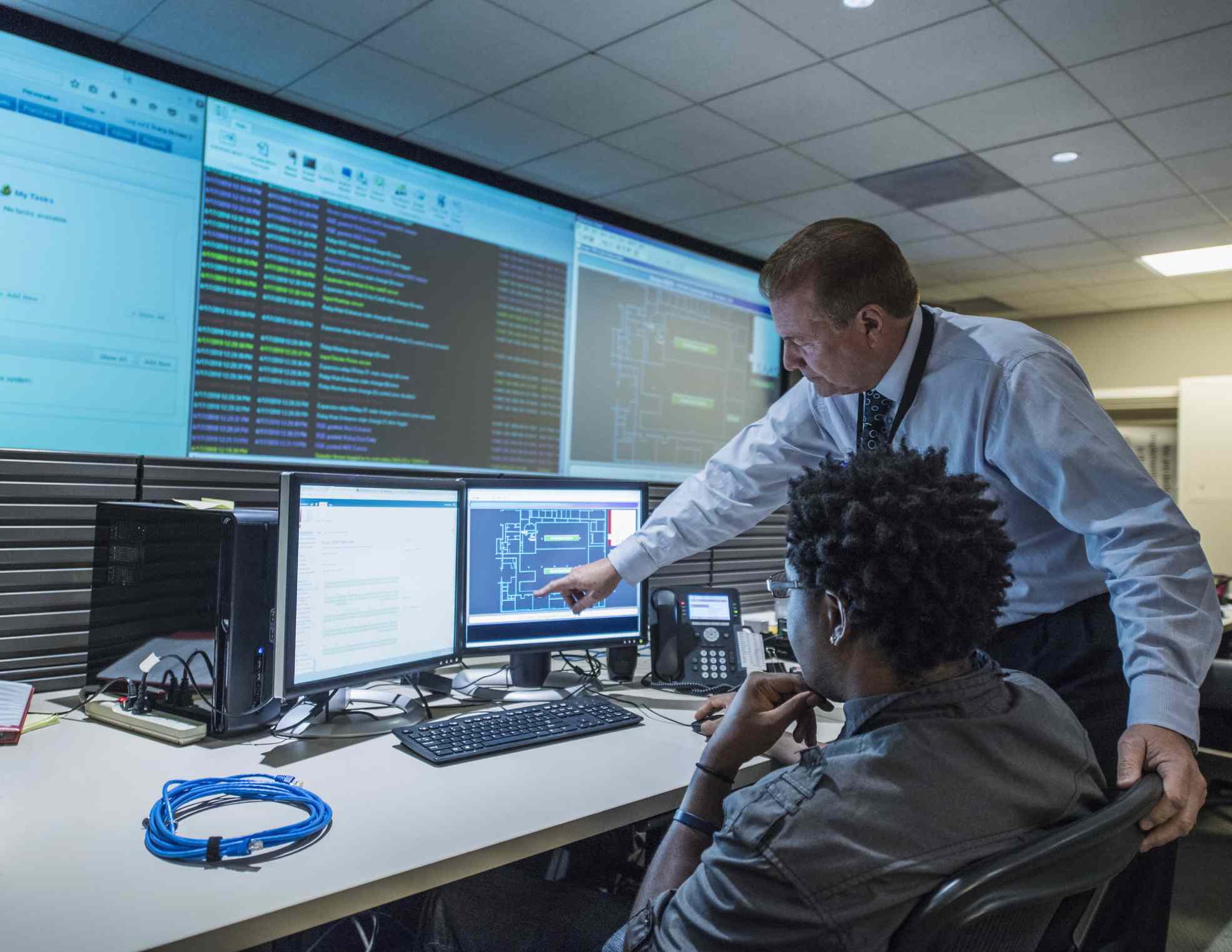 Colleagues working on cyber security issues in control room