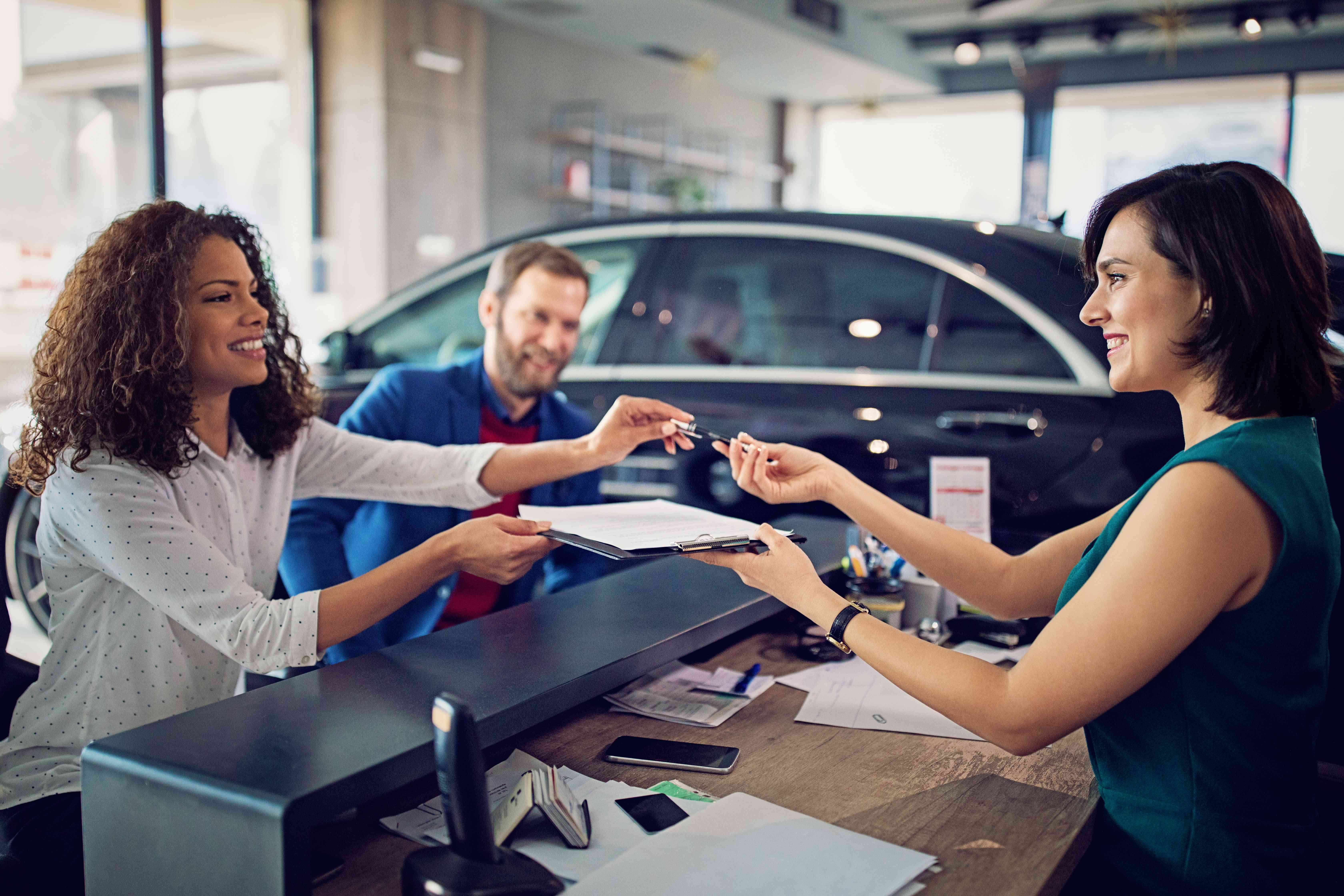 A customer gets keys at a car dealership.