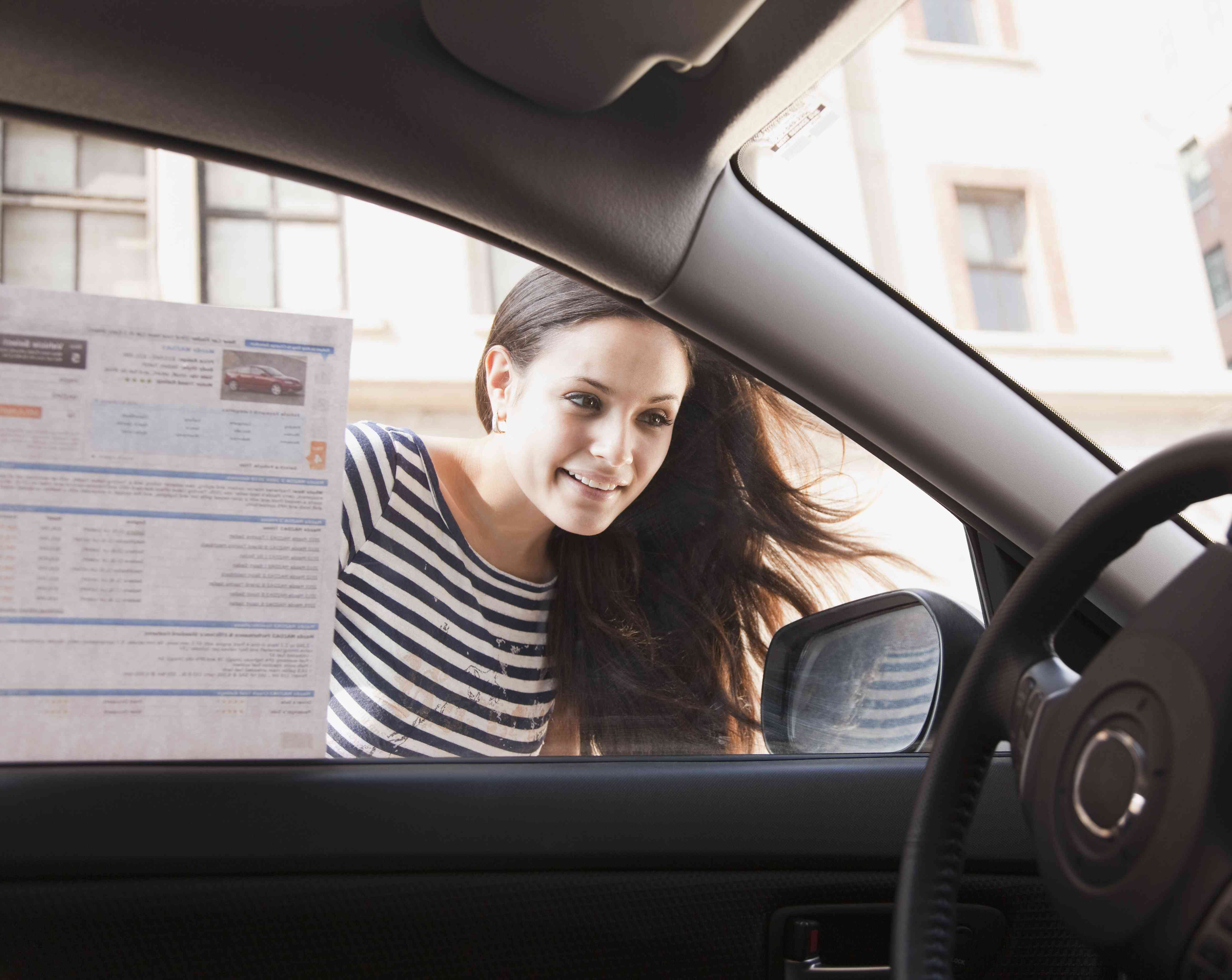 Woman Looks in Window of New Car