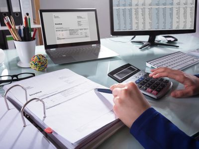 Businessperson Calculating Invoice