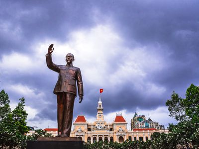 The statue of Ho Chi Minh in Ho Chi Minh City, Vietnam. In the background is the town hall building.