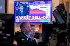 A television displays stock market news on the floor of the New York Stock Exchange (NYSE) in New York on Monday