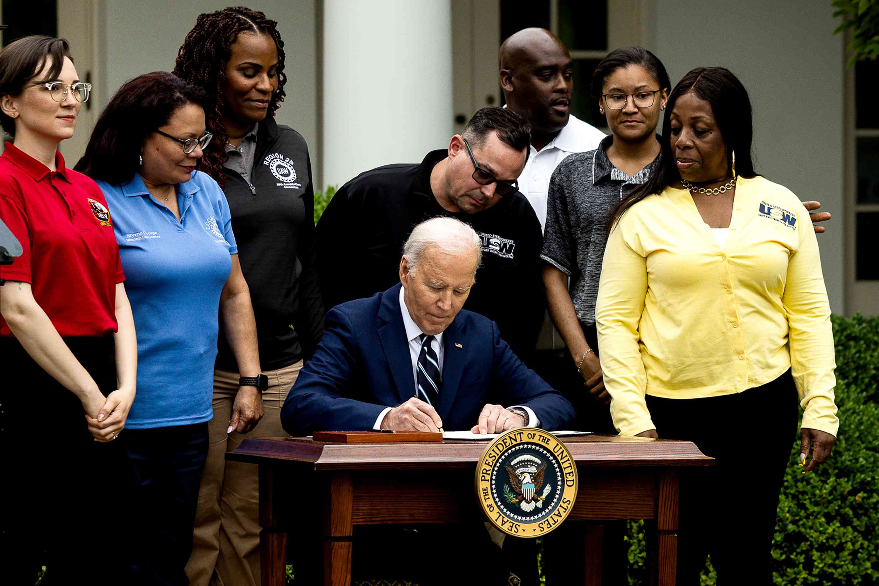 US President Joe Biden, center, signs orders that increase tariffs on China during an event in the Rose Garden of the White House in Washington, DC, US, on Tuesday, May 14, 2024. Biden is hiking tariffs on a wide range of Chinese imports, including semiconductors, batteries, solar cells, and critical minerals, in an election-year bid to bolster domestic manufacturing in critical industries. 