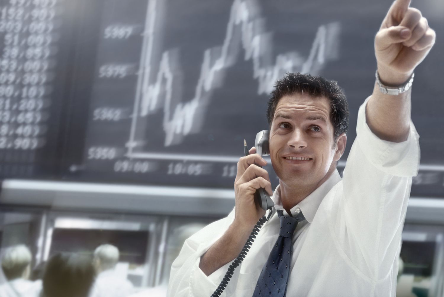 Stock trader on the phone and making trades