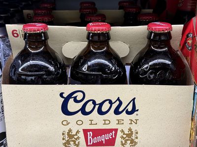 Bottles of Coors beer on a store shelf. 