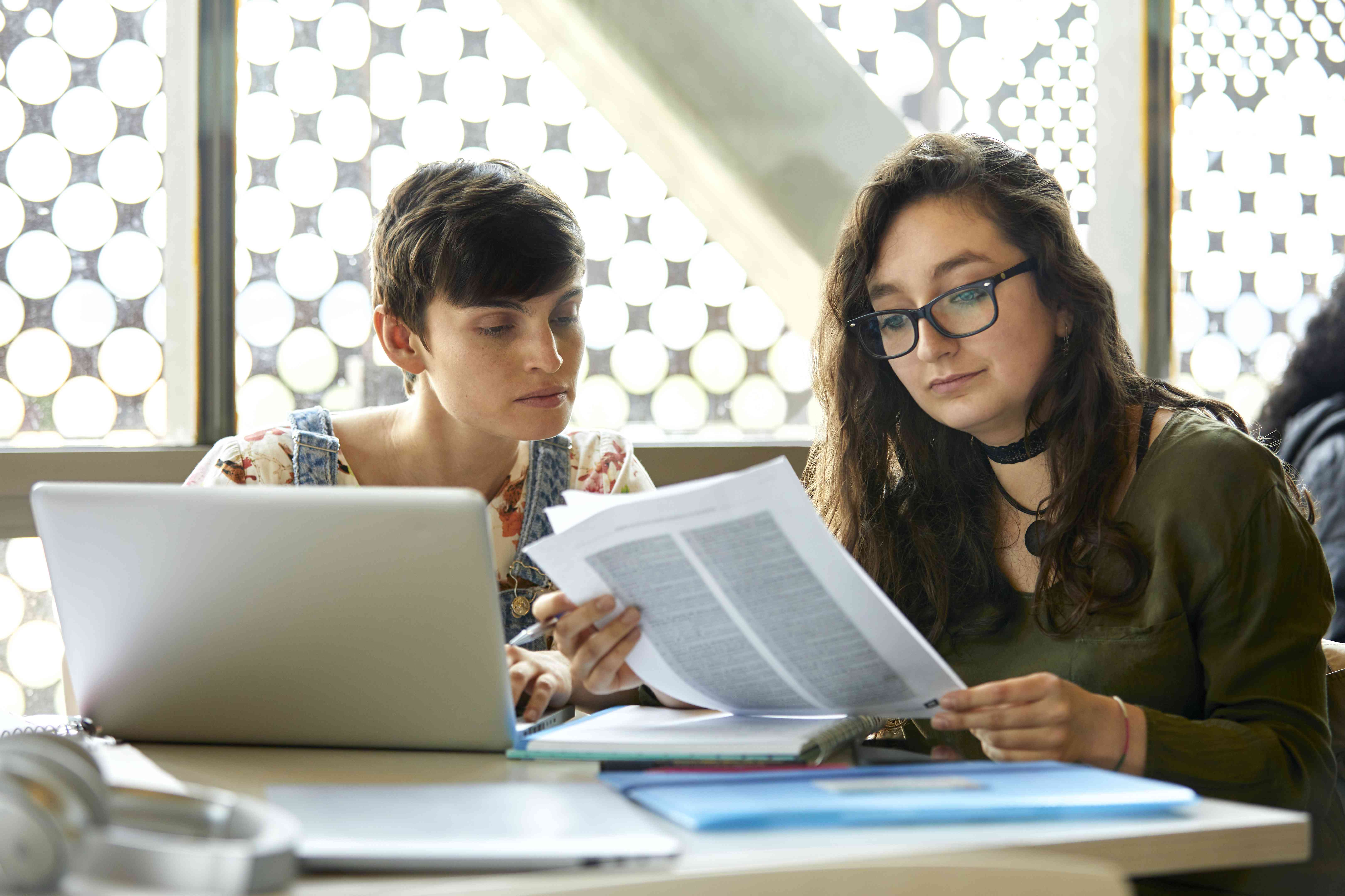 Young women looking at papers together