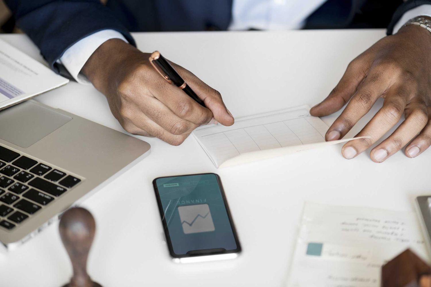 Picture of a man filling out a check