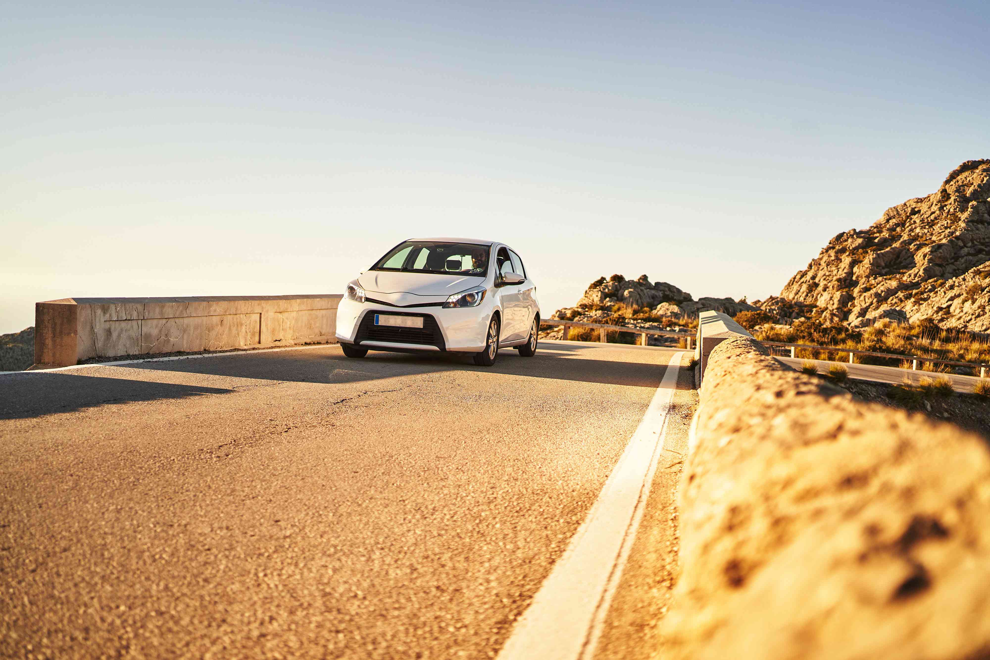 Modern vehicle driving on road in highlands