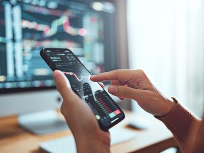 Woman is checking Bitcoin price chart on digital exchange on smartphone, cryptocurrency future price action prediction. Another crisis is coming and prices on the charts are falling down.