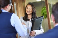 Two people shake hands over a business transaction.