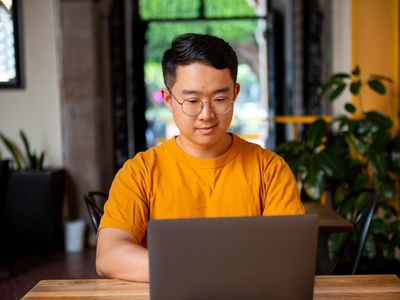 A student researches on laptop to see whether student loans are predatory.