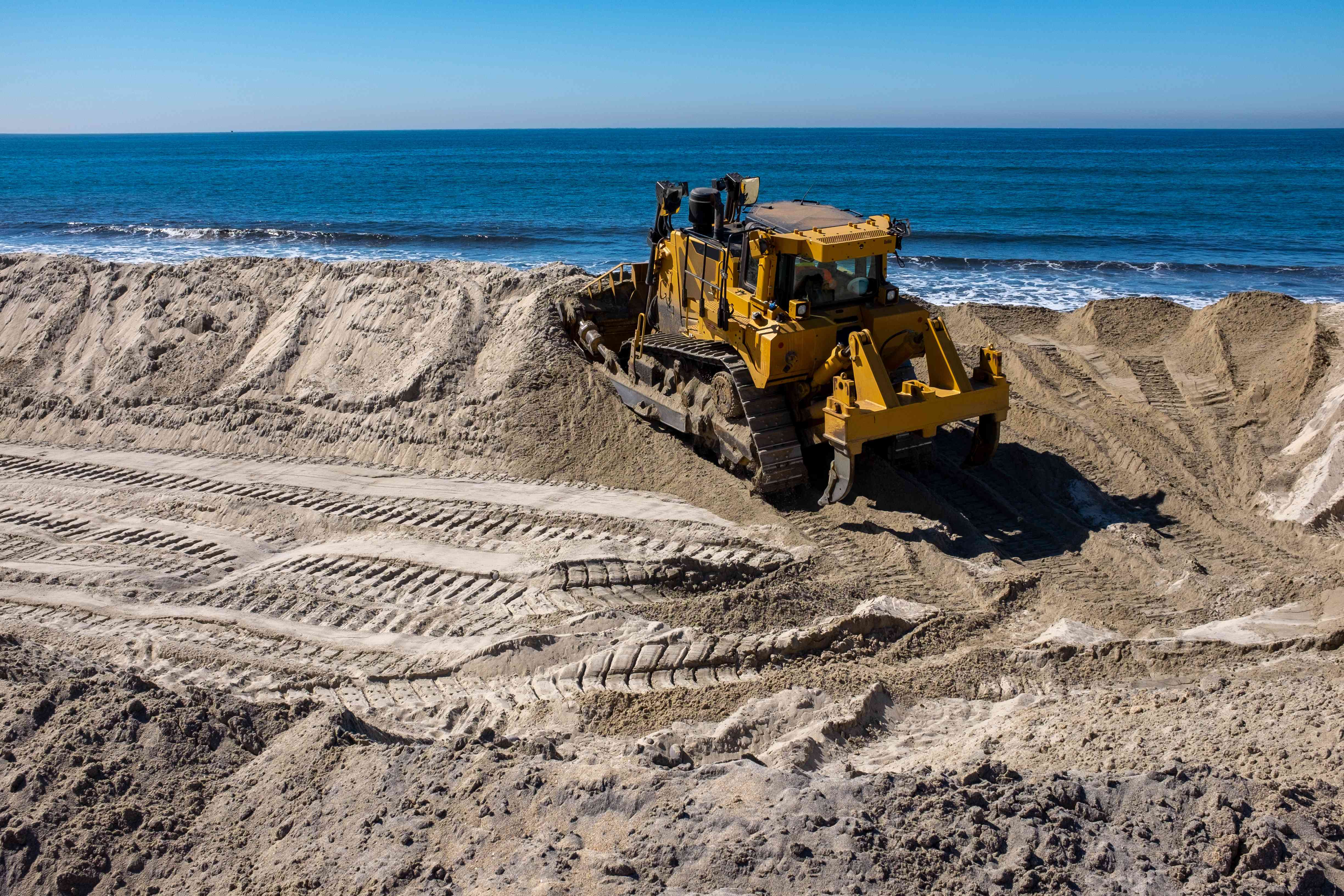 A bulldozer dredges sand for a beach replenishment project in Carlsbad, CA. that is paid for through the issuance of a municipal bond.