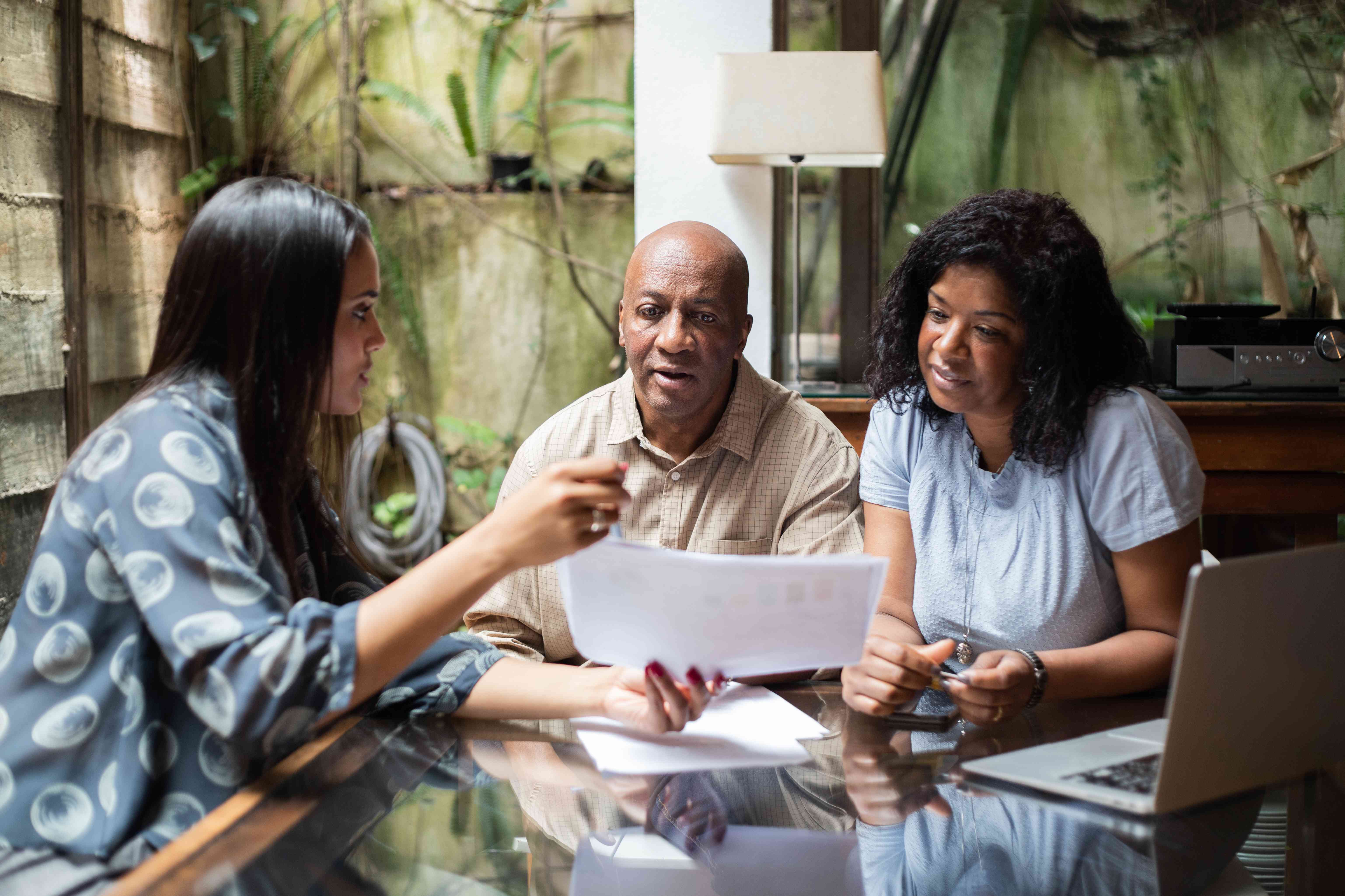 Financial advisor showing a couple a document