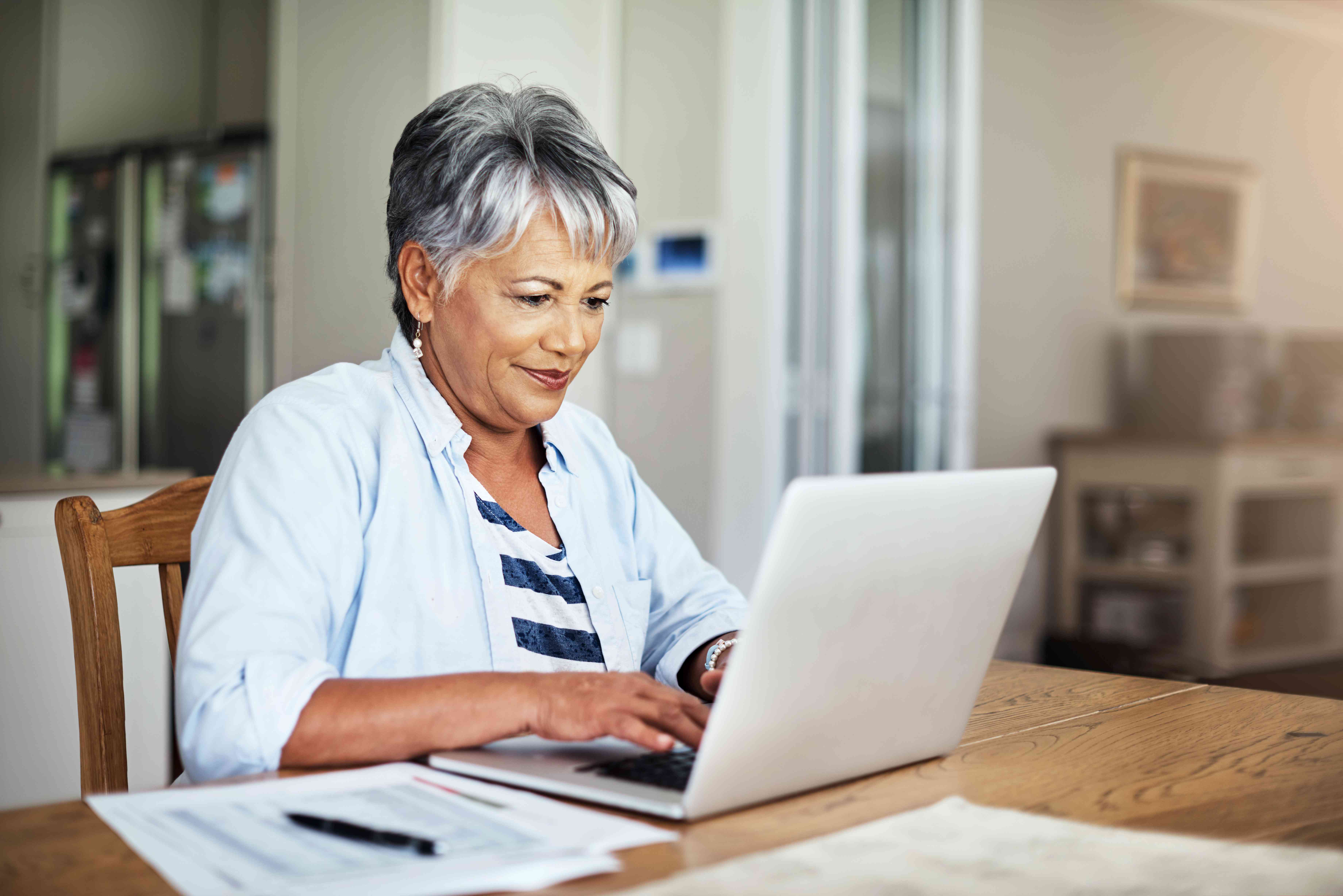 Woman using a laptop at a table