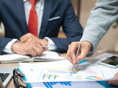 A business meeting analyzing and discussing the situation on the financial report in the meeting room.