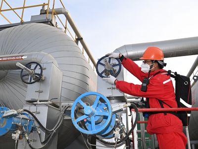 Engineer inspecting pipes in an oil and gas facility