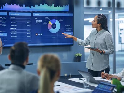 Business woman pointing to graph in meeting room