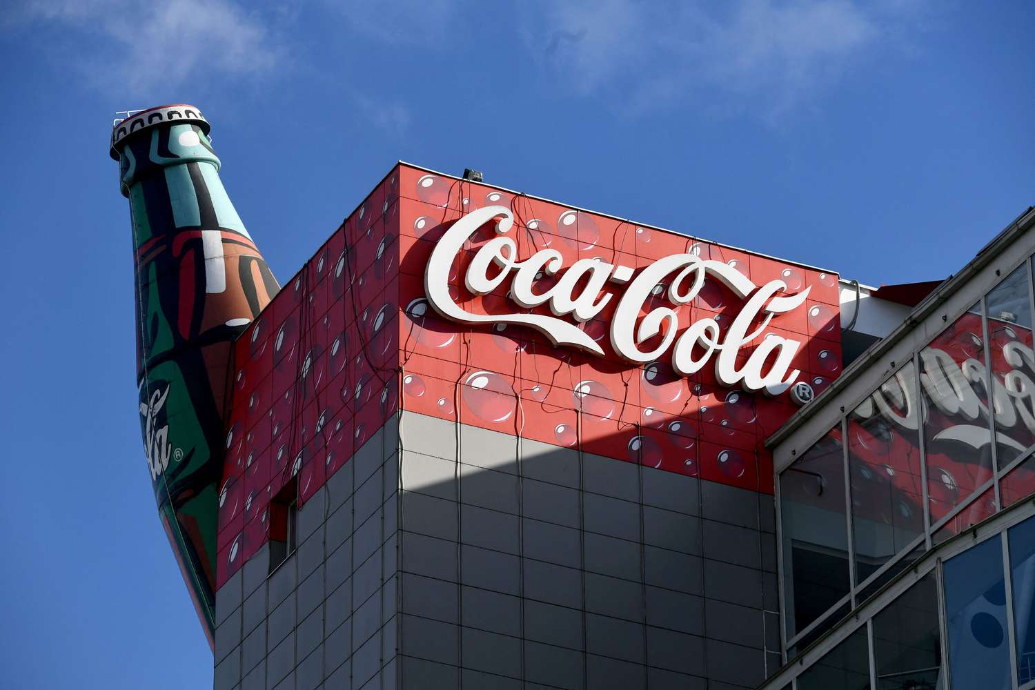 A Coca-Cola logo and bottle are shown on the top of the company's headquarters in Croatia. 