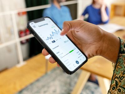 Close-up of woman trading stock online on mobile phone