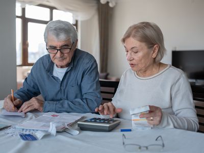 Couple discussing finances with a calculator