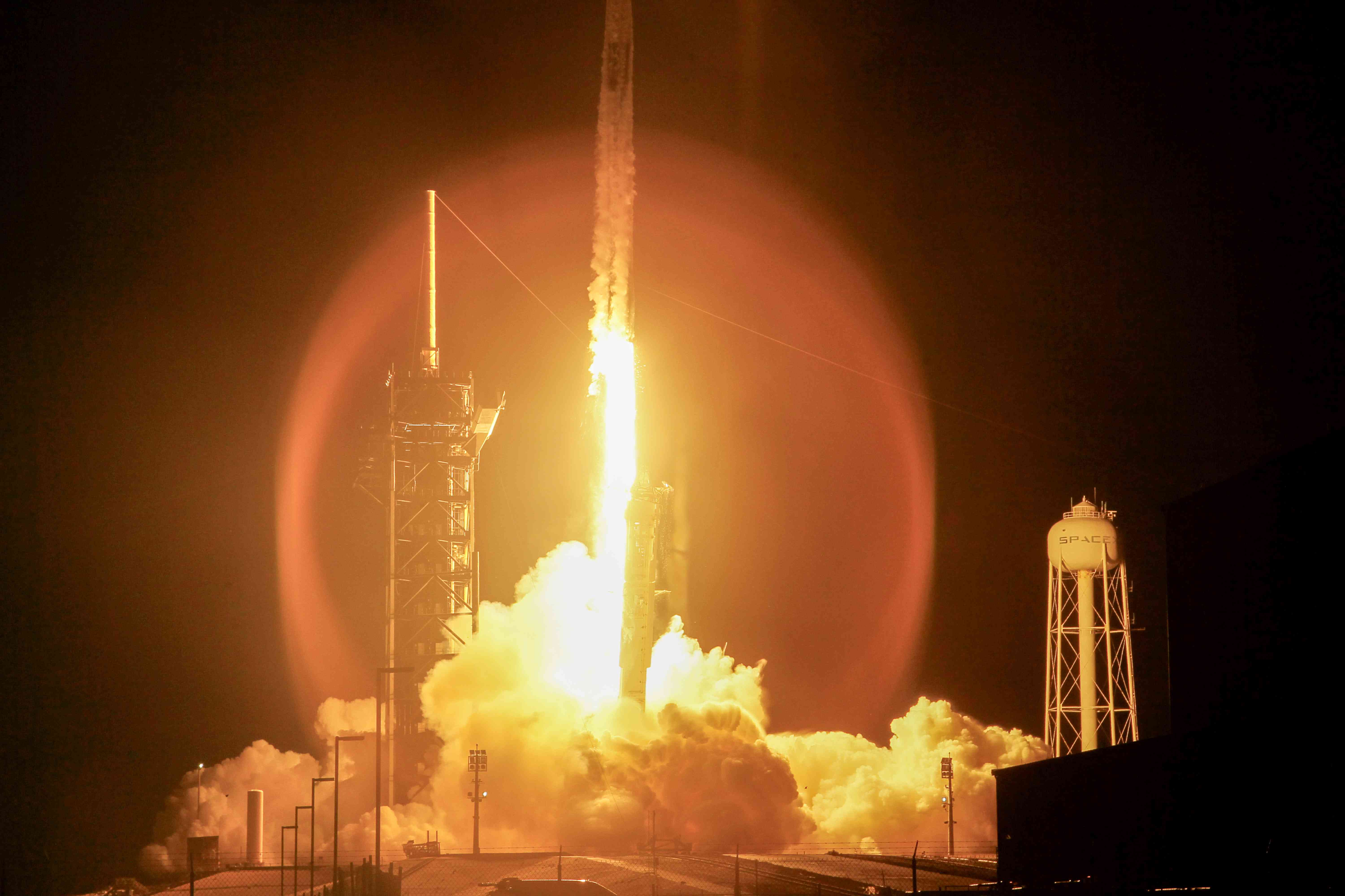 SpaceX's Polaris Dawn Falcon 9 rocket launching, with smoke underneath.