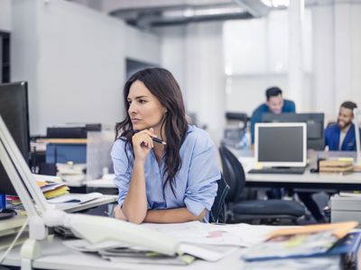 Trader at desk thinking.