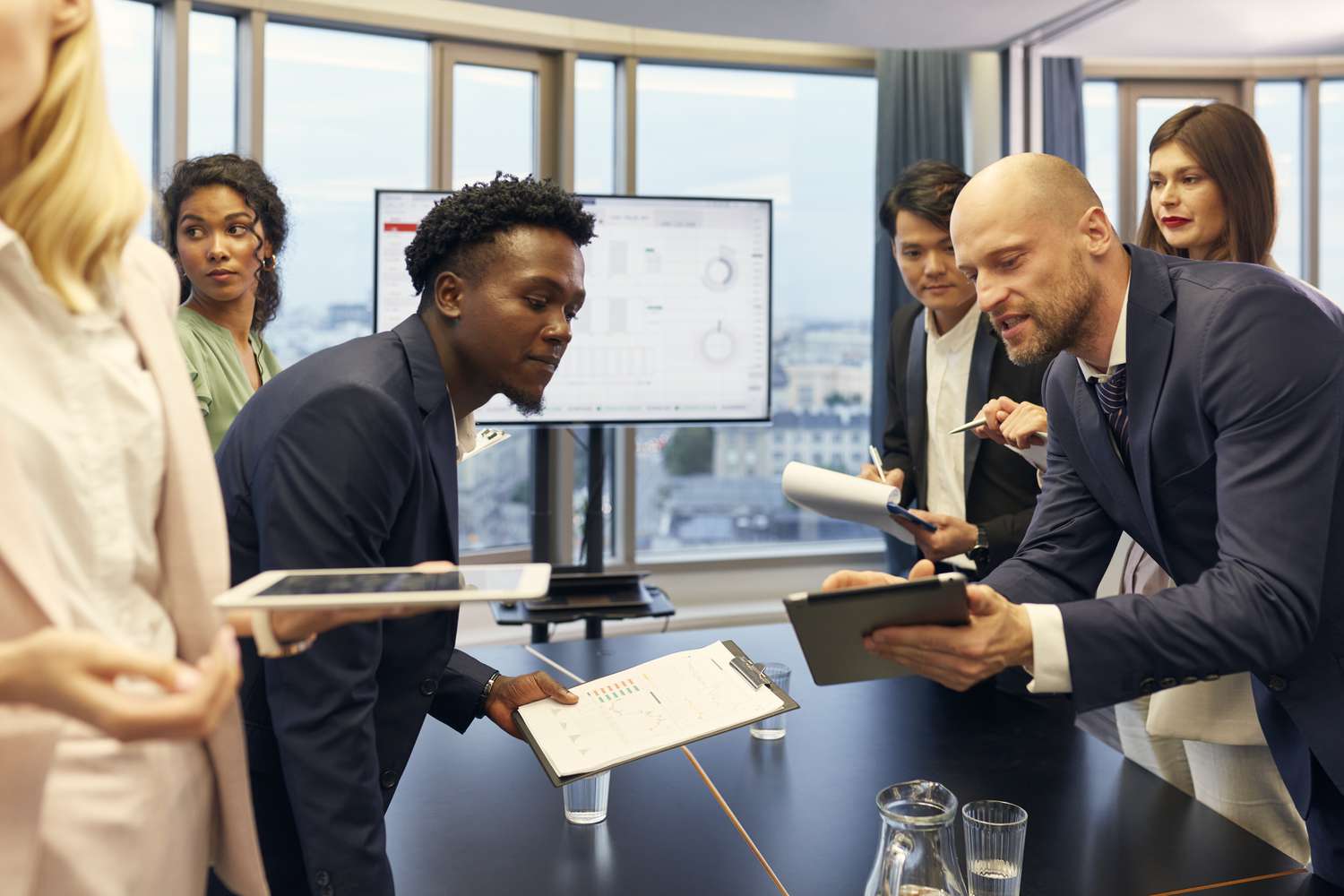 Group of people discussing and coming up with new investment strategies in a meeting.