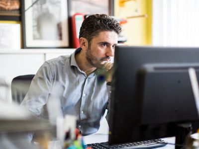 A man uses a desktop computer.