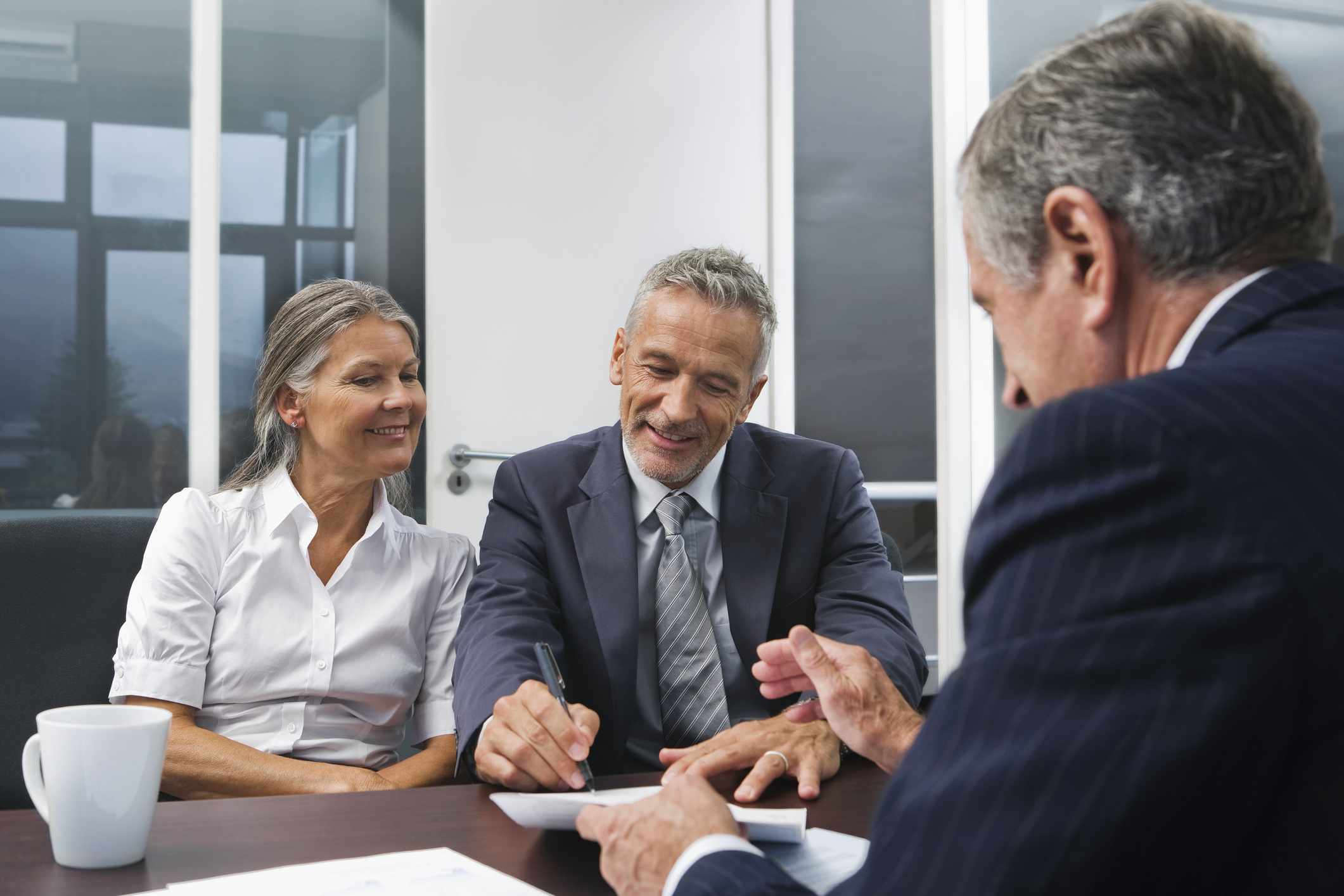 Middle-aged couple talking to financial advisor