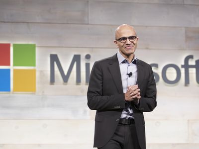 Microsoft CEO Satya Nadella in front of the company's logo. 