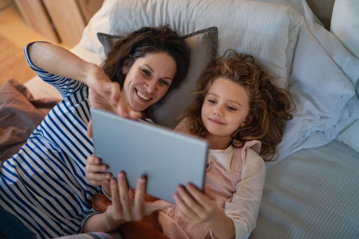 Mother going over tablet with child