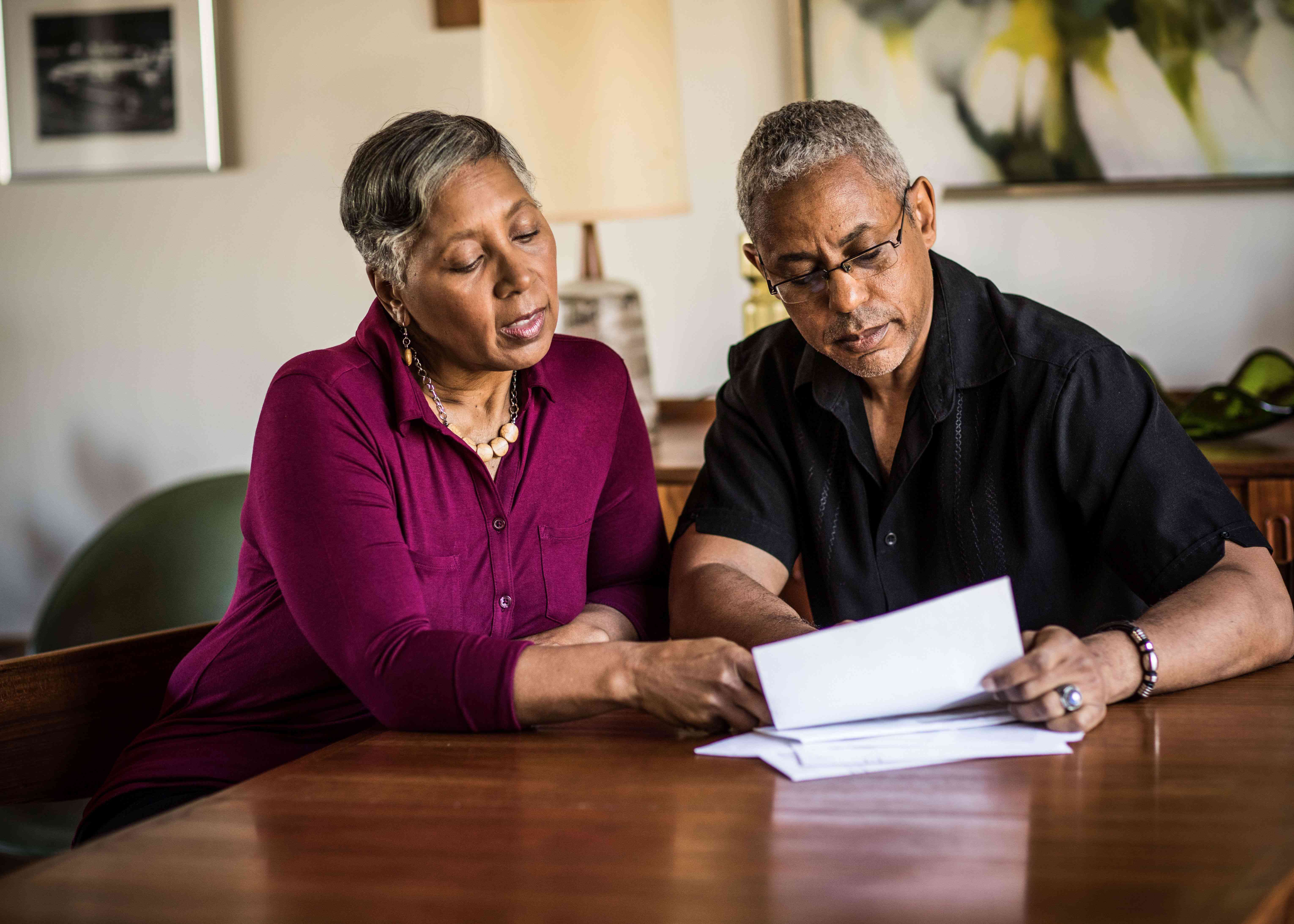 A couple looking at paperwork at a table