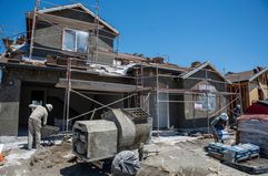 Construction workers at a new housing community in Folsom, California, US, on Wednesday, July 3, 2024.