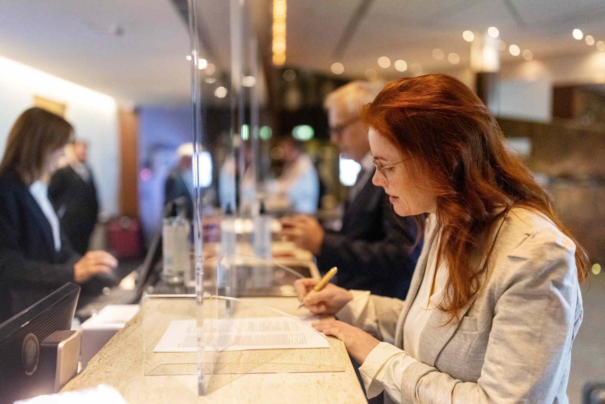 A woman signs documents