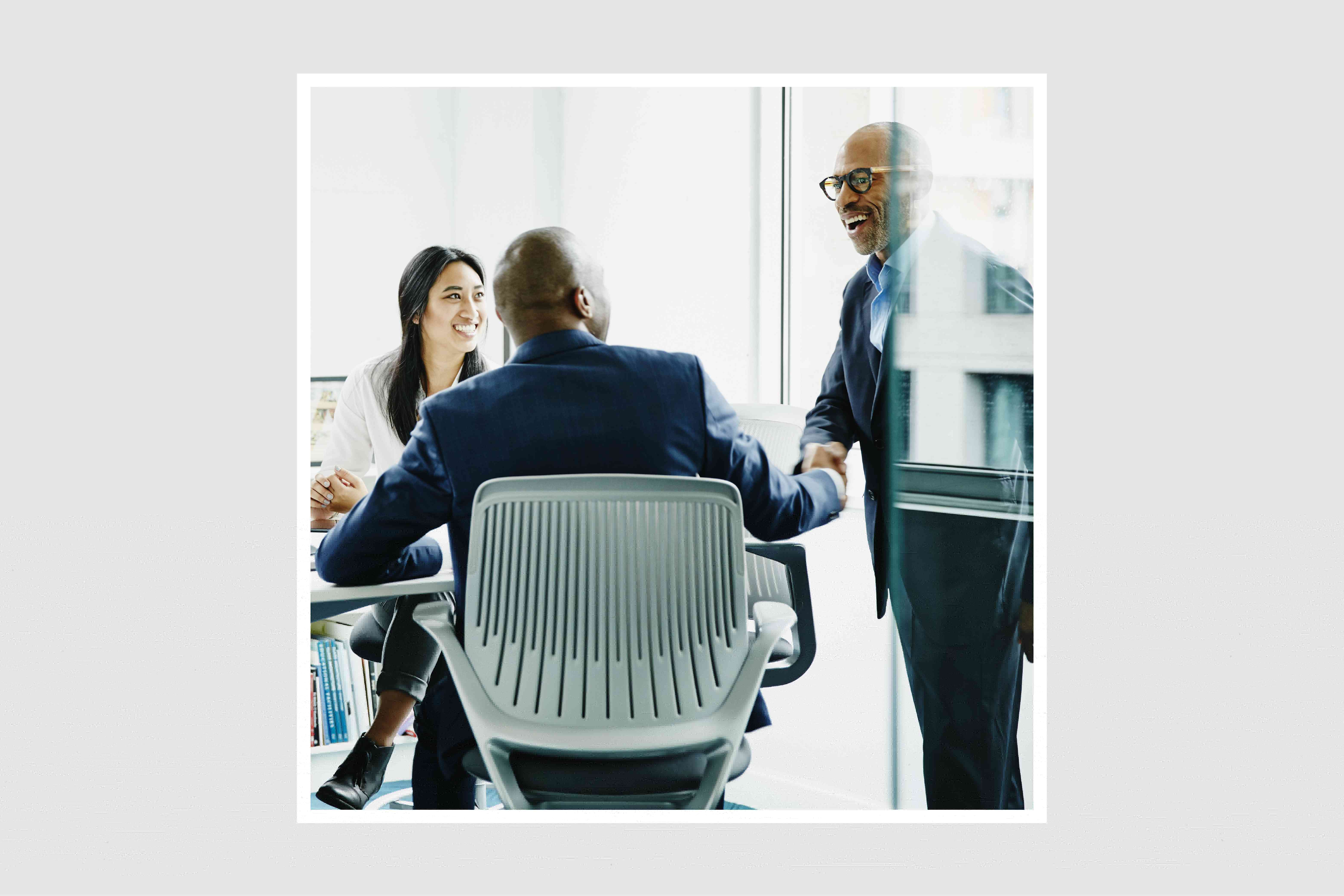 people in a glass conference room