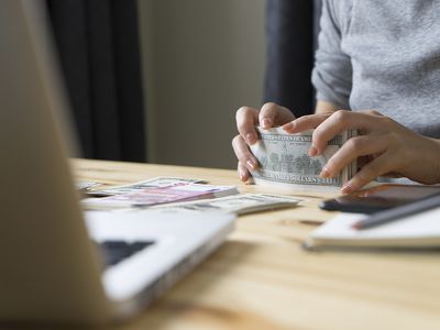 Woman counting money for origination fee