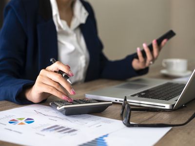 Closeup of female accountant or banker making calculations.