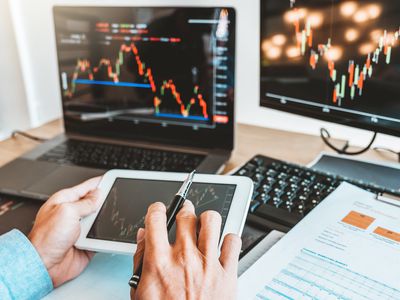 Businessman Analyzing Stock Market Data Over Digital Tablet In Office